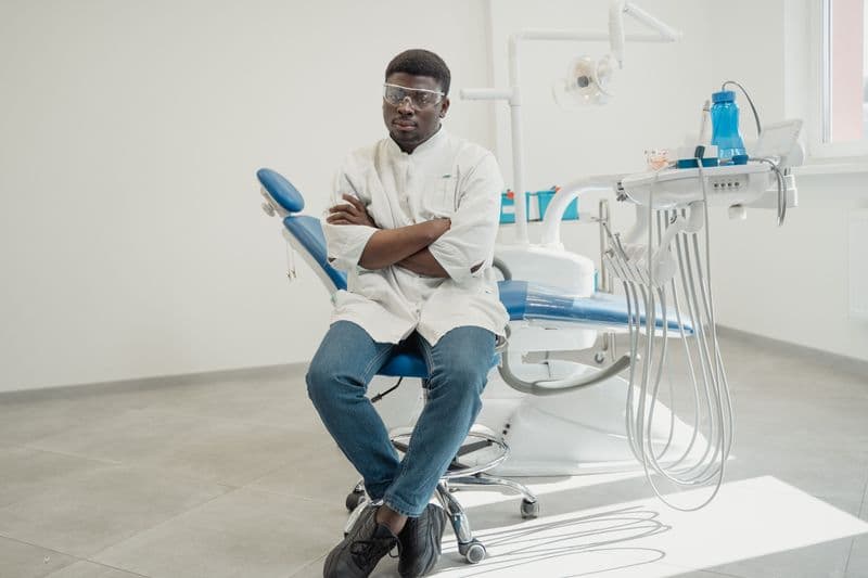 Portrait of Dr. Nathan Park, DMD, MS, a confident male orthodontist in a white coat