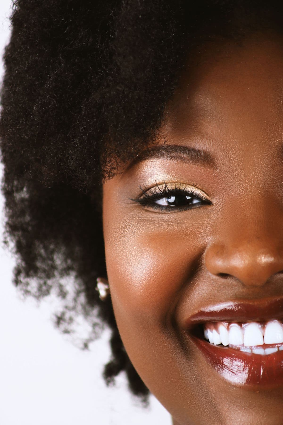 A bold, extreme close up of a bright smile with straight white teeth